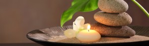 Spa still life with stacked of stone,burning candle and dishgyi leaf.