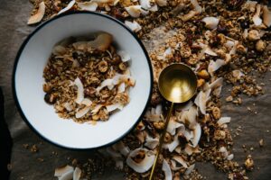 bowl of whole grains next to golden ladle