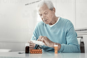Man looking a pill box
