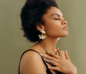 Woman embracing herself thoughtfully, meditating