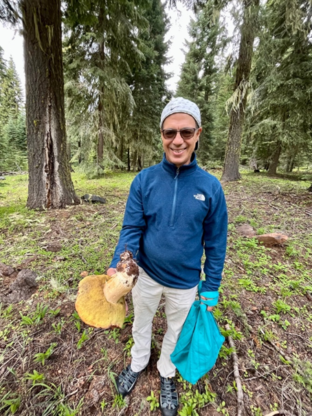 Donnie Yance holding a giant porcini that he harvested in the wild