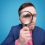 A man looking through a magnifying glass